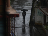 A man walks on the street during rain due to Cyclone Dana in Kolkata, India, on October 25, 2024. The coastal districts of Odisha are batter...