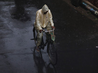 A man rides a bicycle on the street during rain due to Cyclone Dana in Kolkata, India, on October 25, 2024. The coastal districts of Odisha...