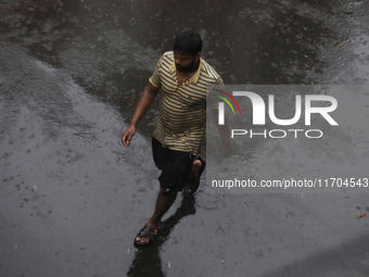 A man walks on the street during rain due to Cyclone Dana in Kolkata, India, on October 25, 2024. The coastal districts of Odisha are batter...