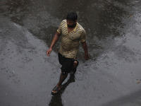 A man walks on the street during rain due to Cyclone Dana in Kolkata, India, on October 25, 2024. The coastal districts of Odisha are batter...