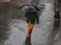 A woman walks on the street during rain due to Cyclone Dana in Kolkata, India, on October 25, 2024. The coastal districts of Odisha are batt...