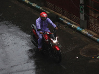 A man rides a motorcycle on the street during rain due to Cyclone Dana in Kolkata, India, on October 25, 2024. The coastal districts of Odis...