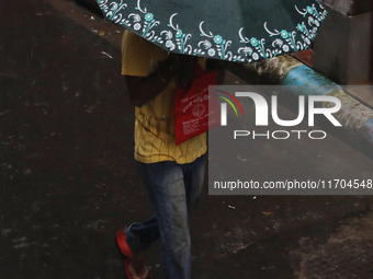 A man walks on the street during rain due to Cyclone Dana in Kolkata, India, on October 25, 2024. The coastal districts of Odisha are batter...