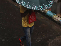 A man walks on the street during rain due to Cyclone Dana in Kolkata, India, on October 25, 2024. The coastal districts of Odisha are batter...