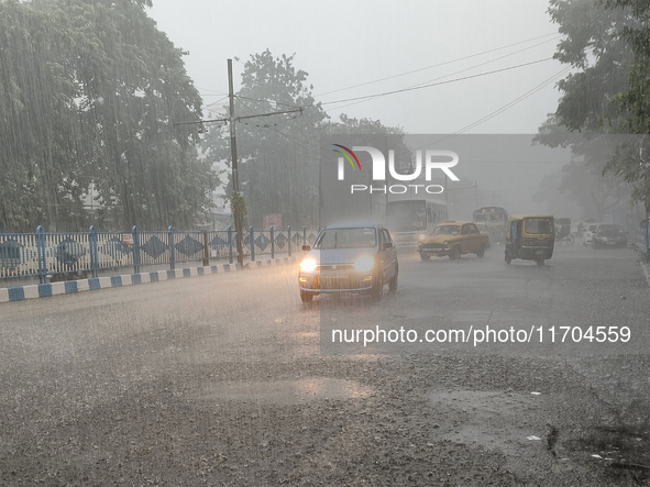 Public vehicles run on the street during the heavy rain due to Cyclone Dana in Kolkata, India, on October 25, 2024. 