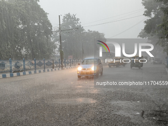 Public vehicles run on the street during the heavy rain due to Cyclone Dana in Kolkata, India, on October 25, 2024. (