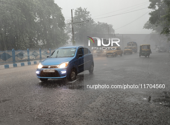 Public vehicles run on the street during the heavy rain due to Cyclone Dana in Kolkata, India, on October 25, 2024. 