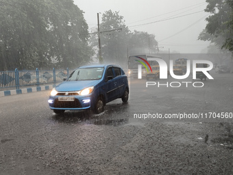 Public vehicles run on the street during the heavy rain due to Cyclone Dana in Kolkata, India, on October 25, 2024. (