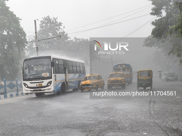 Public vehicles run on the street during the heavy rain due to Cyclone Dana in Kolkata, India, on October 25, 2024. 