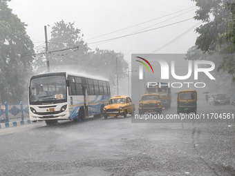 Public vehicles run on the street during the heavy rain due to Cyclone Dana in Kolkata, India, on October 25, 2024. (