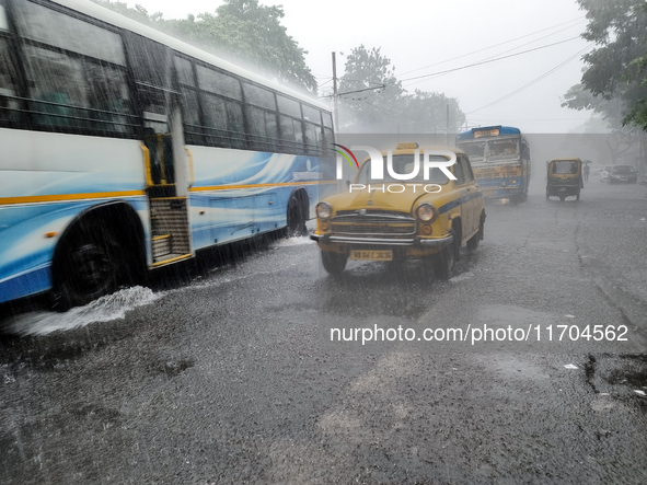 Public vehicles run on the street during the heavy rain due to Cyclone Dana in Kolkata, India, on October 25, 2024. 