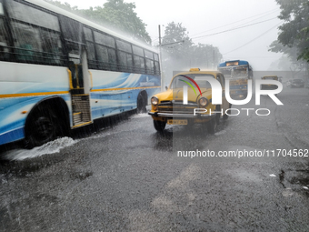 Public vehicles run on the street during the heavy rain due to Cyclone Dana in Kolkata, India, on October 25, 2024. (