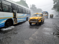 Public vehicles run on the street during the heavy rain due to Cyclone Dana in Kolkata, India, on October 25, 2024. (