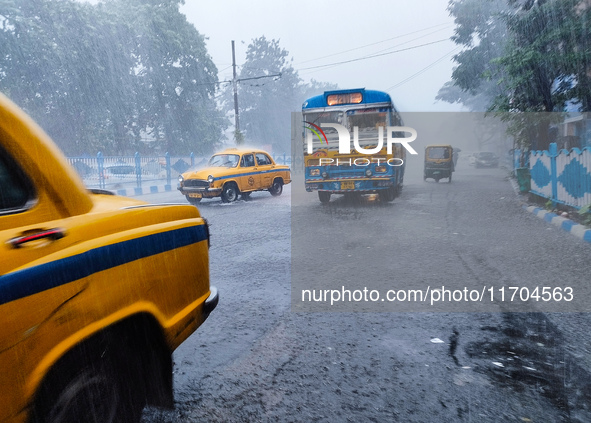 Public vehicles run on the street during the heavy rain due to Cyclone Dana in Kolkata, India, on October 25, 2024. 