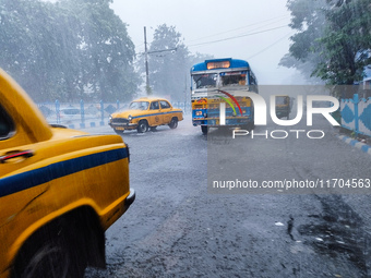 Public vehicles run on the street during the heavy rain due to Cyclone Dana in Kolkata, India, on October 25, 2024. (