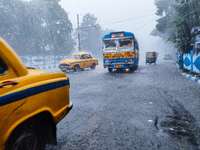 Public vehicles run on the street during the heavy rain due to Cyclone Dana in Kolkata, India, on October 25, 2024. (