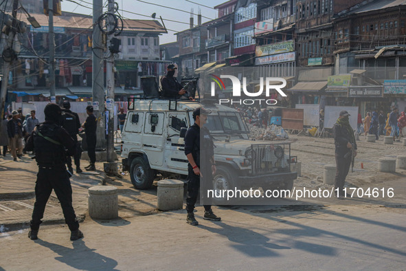 Indian security personnel stand guard along a road in Srinagar, Jammu and Kashmir, on October 25, 2024. Security is increased across Kashmir...