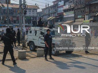 Indian security personnel stand guard along a road in Srinagar, Jammu and Kashmir, on October 25, 2024. Security is increased across Kashmir...