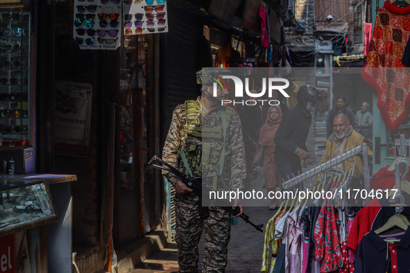 An Indian security personnel watches over as he guards along a road in Srinagar, Jammu and Kashmir, on October 25, 2024. Security is beefed...