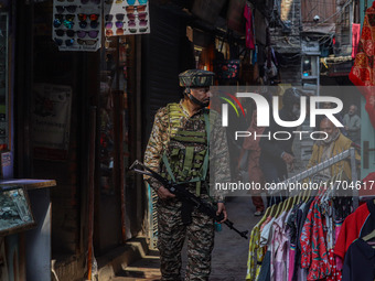 An Indian security personnel watches over as he guards along a road in Srinagar, Jammu and Kashmir, on October 25, 2024. Security is beefed...