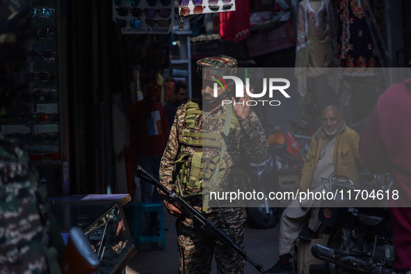 An Indian security personnel watches over as he guards along a road in Srinagar, Jammu and Kashmir, on October 25, 2024. Security is beefed...