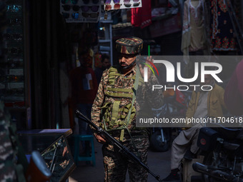 An Indian security personnel watches over as he guards along a road in Srinagar, Jammu and Kashmir, on October 25, 2024. Security is beefed...