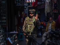 An Indian security personnel watches over as he guards along a road in Srinagar, Jammu and Kashmir, on October 25, 2024. Security is beefed...