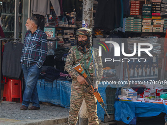 An Indian security personnel stands guard along a road in Srinagar, Jammu and Kashmir, on October 25, 2024. Security is increased across Kas...