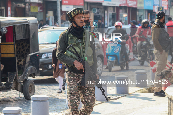 An Indian security personnel guards along a road in Srinagar, Jammu and Kashmir, on October 25, 2024. Security is increased across Kashmir f...