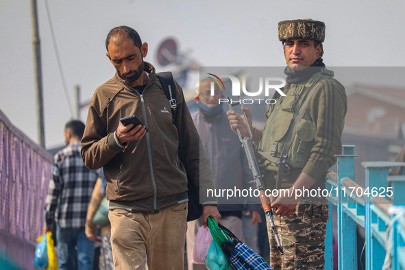 An Indian security personnel stands guard along a road in Srinagar, Jammu and Kashmir, on October 25, 2024. Security is increased across Kas...