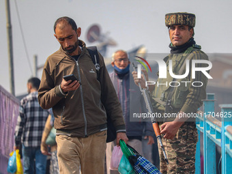 An Indian security personnel stands guard along a road in Srinagar, Jammu and Kashmir, on October 25, 2024. Security is increased across Kas...