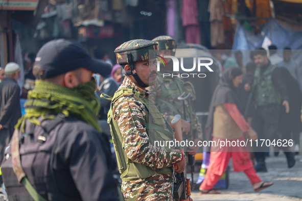 Indian security personnel stand guard along a road in Srinagar, Jammu and Kashmir, on October 25, 2024. Security is increased across Kashmir...