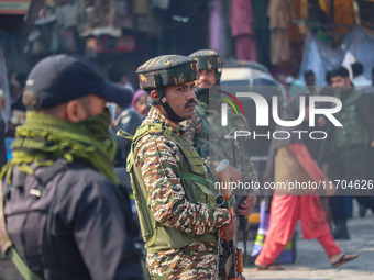 Indian security personnel stand guard along a road in Srinagar, Jammu and Kashmir, on October 25, 2024. Security is increased across Kashmir...