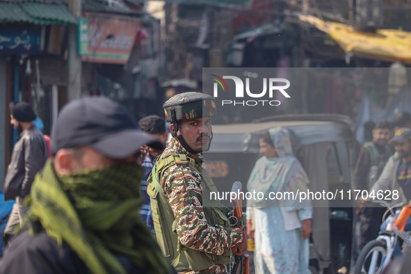 Indian security personnel stand guard along a road in Srinagar, Jammu and Kashmir, on October 25, 2024. Security is increased across Kashmir...