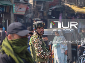 Indian security personnel stand guard along a road in Srinagar, Jammu and Kashmir, on October 25, 2024. Security is increased across Kashmir...