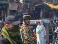 Indian security personnel stand guard along a road in Srinagar, Jammu and Kashmir, on October 25, 2024. Security is increased across Kashmir...