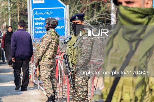 Indian security personnel stand guard along a road in Srinagar, Jammu and Kashmir, on October 25, 2024. Security is increased across Kashmir...