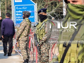 Indian security personnel stand guard along a road in Srinagar, Jammu and Kashmir, on October 25, 2024. Security is increased across Kashmir...