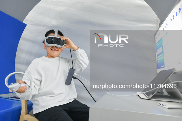 A child experiences a VR interstellar map at the 7th World Sound Expo and IFlytek Global 1024 Developer Festival in Hefei, China, on October...