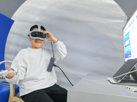 A child experiences a VR interstellar map at the 7th World Sound Expo and IFlytek Global 1024 Developer Festival in Hefei, China, on October...