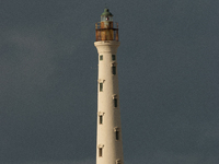 The California Lighthouse, known by locals as Faro, stands tall on a limestone plateau at Hudishibana, near Arashi Beach and Sasariwichi dun...