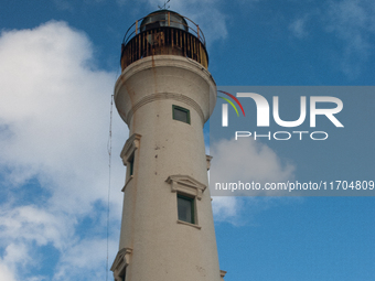 The California Lighthouse, known by locals as Faro, stands tall on a limestone plateau at Hudishibana, near Arashi Beach and Sasariwichi dun...