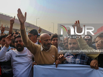 Member of Parliament Sheikh Abdul Rashid, also known as Engineer Rashid, (C) shouts slogans during a protest in Srinagar, Jammu and Kashmir,...