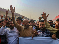 Member of Parliament Sheikh Abdul Rashid, also known as Engineer Rashid, (C) shouts slogans during a protest in Srinagar, Jammu and Kashmir,...