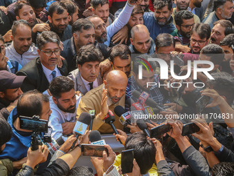 Member of Parliament Sheikh Abdul Rashid, also known as Engineer Rashid, (C) talks with members of the media during a protest in Srinagar, J...