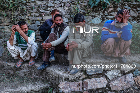 People wait for the funeral ceremony of a potter named Mushtaq Ahmad Chowdhary, who works with the Indian army and is killed during a milita...