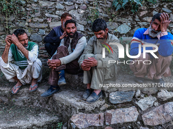 People wait for the funeral ceremony of a potter named Mushtaq Ahmad Chowdhary, who works with the Indian army and is killed during a milita...