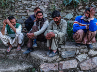 People wait for the funeral ceremony of a potter named Mushtaq Ahmad Chowdhary, who works with the Indian army and is killed during a milita...