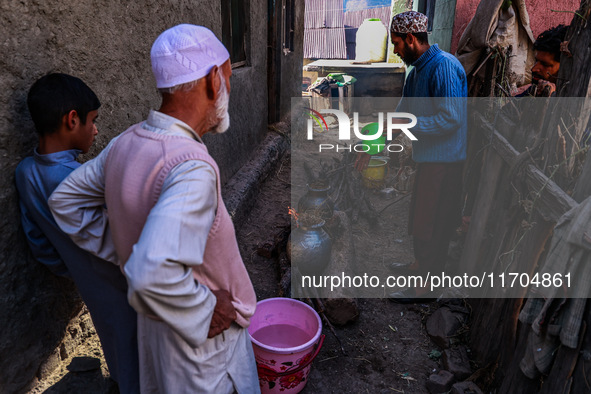 Relatives prepare for the funeral ceremony of Mushtaq Ahmad Chowdhary, a defense potter who is killed during an attack in which Indian Army...