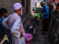 Relatives prepare for the funeral ceremony of Mushtaq Ahmad Chowdhary, a defense potter who is killed during an attack in which Indian Army...